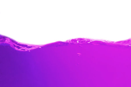 purple water splash isolated on white background with copy space for textの写真素材
