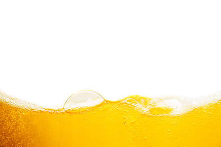Beer foam with bubbles on a white background. Close-up.