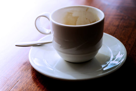 Coffee cup on wooden table in coffee shop, stock photo