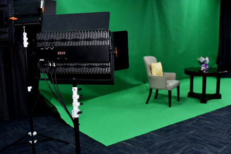 Professional video camera on the background of the green curtains in the studioの写真素材