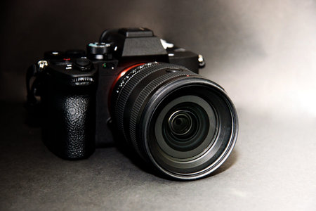 Mirrorless digital camera on black background. Isolated