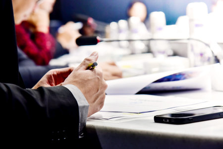Close up of business people hands working together at meeting table in conference room