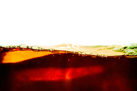 close up of cola in water with bubbles isolated on white backgroundの写真素材