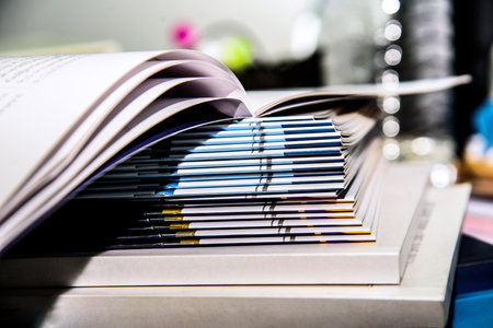 Close up of a stack of books with pencils on the tableの写真素材