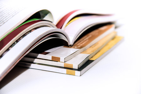 Close up of a stack of books on a white background. Selective focus.の写真素材