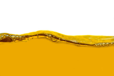 Yellow liquid with bubbles isolated on a white background. Close up.の写真素材