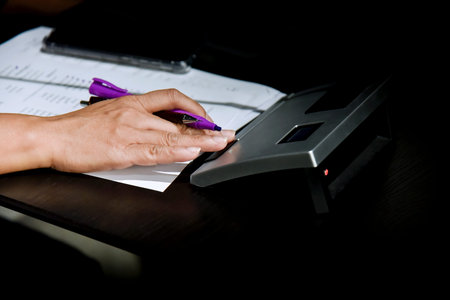 Close-up of businesswoman's hand working with documents in office