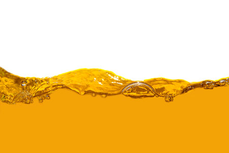 Yellow liquid splash with bubbles isolated on white background. Clipping pathの写真素材