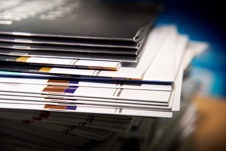 Stack of magazines on the table. Shallow depth of field. Toned.