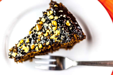 chockolate cake slice on white plate with silver forkの写真素材