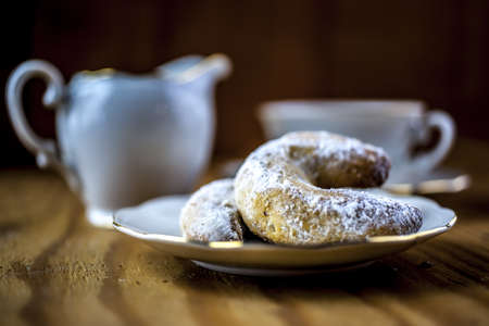 White cup of coffee and white jug of cofee and croissantsの写真素材
