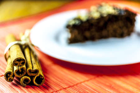 chockolate cake slice and cinamon sticks at the orange matの写真素材