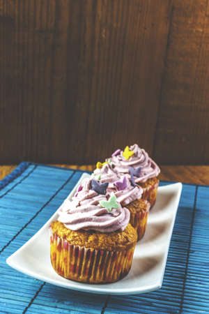 Pink muffins closeup at thee blue matの写真素材