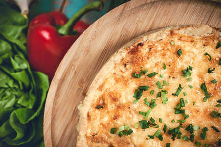French cuisine. Homemade quiche lorraine with vegetables and eggs on rustic wooden blue background. Top viewの写真素材