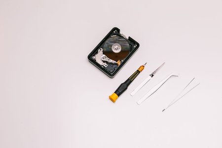 Broken hard drive and tools. Technology maintenance concept