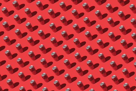 Madrid, Spain - November 26, 2021: Coca cola cans pattern with hard shadow on red background.のeditorial素材