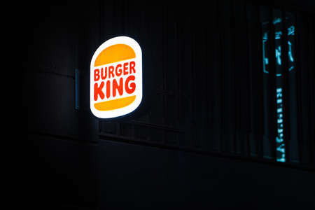 Madrid, Spain - December 05, 2021: Burger King luminous sign on a street wall at night.のeditorial素材