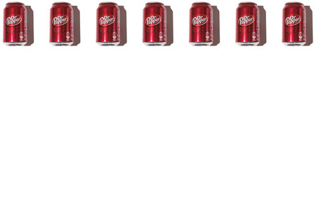 Dr. Pepper cans pattern on top, with hard shadow on white background.