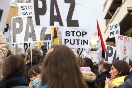 MADRID, SPAIN - FEBRUARY 24: Demonstrators go to the Russian embassy in Madrid to protest against Russia's invasion of Ukraine. Concept of war and invasion.のeditorial素材