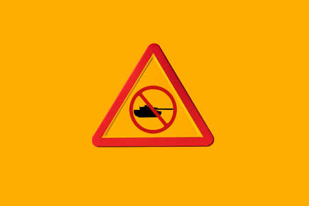 Danger traffic sign with a military tank with the forbidden symbol on a yellow background. Concept of War, Russia and war conflict.の写真素材