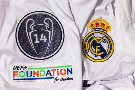 Shield on the white shirt of Real Madrid Football Club, along with the shield of 14 European Cups and the UEFA Foundation sign. Uefa champions league final concept on May 28, 2022.のeditorial素材