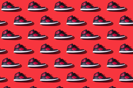 Pattern of NIKE Jordan Access sneakers in black and red, on a red background. Concept of sneaker, basketball, retro, michael jordan, fashion, collection and casualのeditorial素材