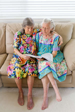 Two Elderly Widows Reading A Bookの写真素材
