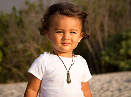 Toddler boy at the beach at sunset の写真素材