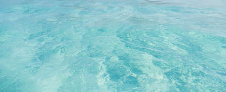 Aqua colored clear ocean water is perfect for use as a background の写真素材