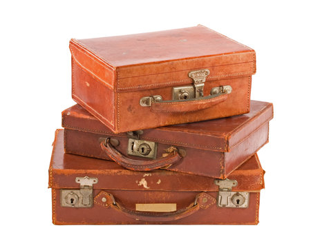 Pile of three old suitcases, isolated on white