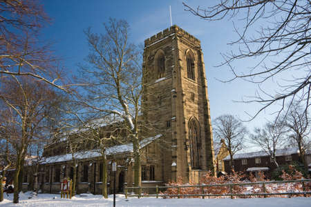 English Church in Snow, framed by branchesの写真素材
