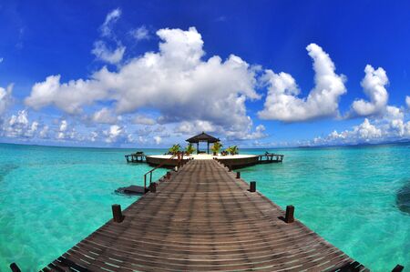 A man-made walkway Kapalai island with exotic tropical resortの写真素材