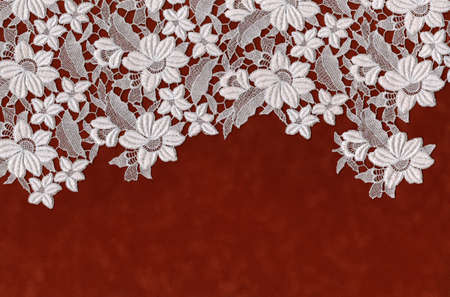 embroidered flowers laid over red velvet paperの写真素材