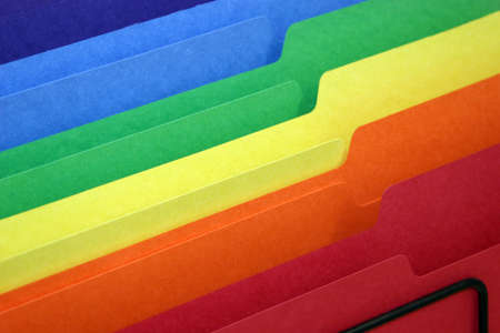 rainbow colored tabbed file folders in a basketの写真素材