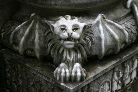 gargoyle statue on pillarの写真素材