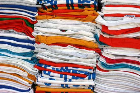 stacked and folded  t-shirts in many colorsの写真素材