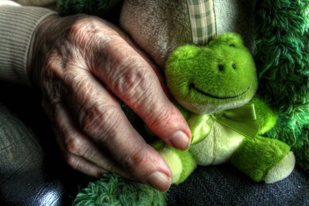 Elderly hand with doll 2の写真素材
