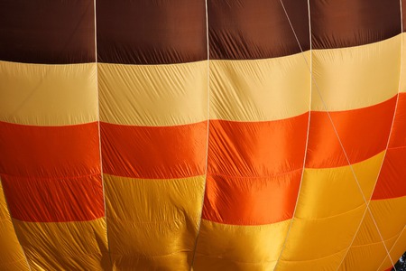 Hot air balloon background of yellow brown orange Close-up view of a colourful hot-air balloon to use as backgroundの写真素材