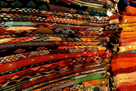 Hand woven morrocan carpets displayed in a marketplaceの写真素材