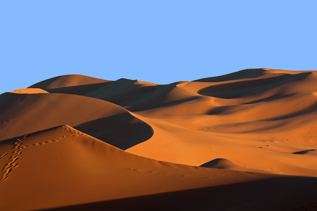 Moroccan Sahara sand dunes and shadows at sunsetの写真素材