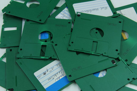 Old green floppy disks destroyed for recycling and securityの写真素材
