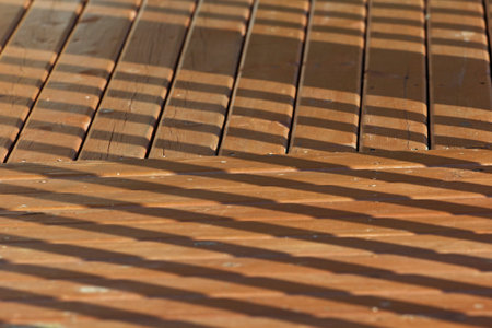 Sun shines through on wooden boards background