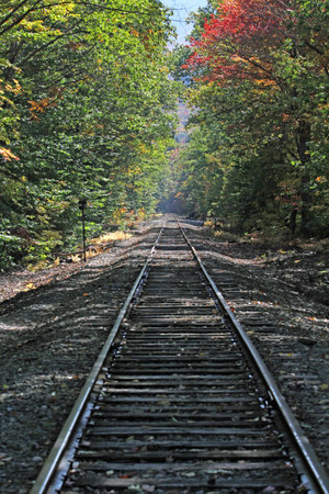 Rusty old train bridge in the fall on a sunny dayの写真素材