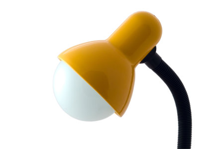 Yellow luminescent desk lamp on white backgroundの写真素材