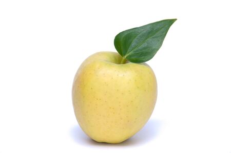 Green apple with sheet on white backgroundの写真素材