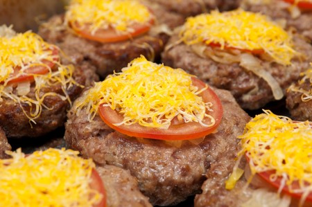 Fried beefsteak with a tomato and cheeseの写真素材