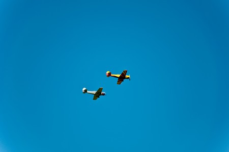 Two sports planes in the dark blue skyの写真素材