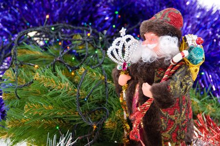 Santa Claus with gifts under a fur-treeの写真素材