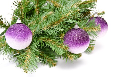 Three gold balls on a Christmas fur-treeの写真素材