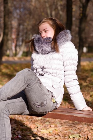 young girl on a park benchの写真素材